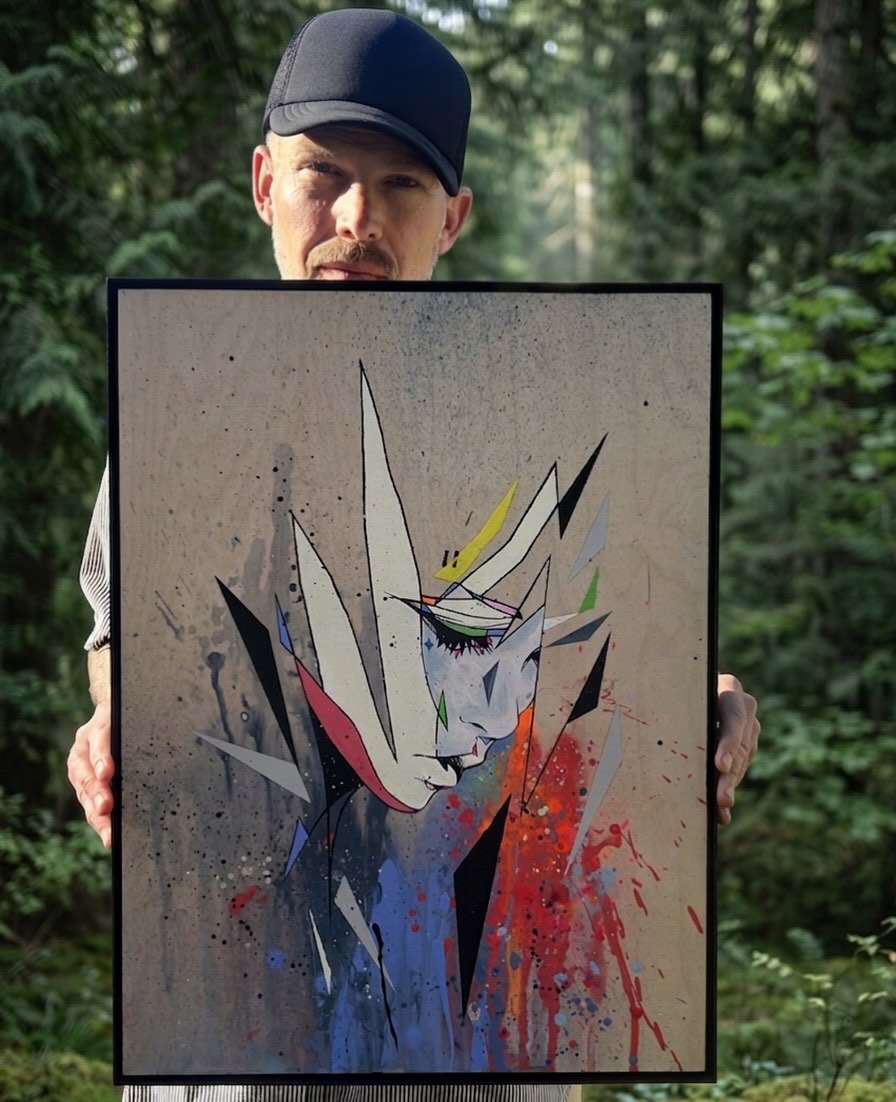 Ben Tour holding a custom framed portrait painting in a forest
